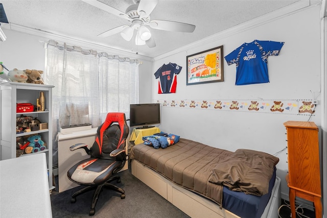 bedroom with a textured ceiling, ceiling fan, carpet flooring, and crown molding