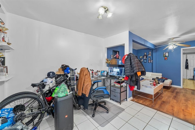 office space with ceiling fan, baseboards, and tile patterned floors