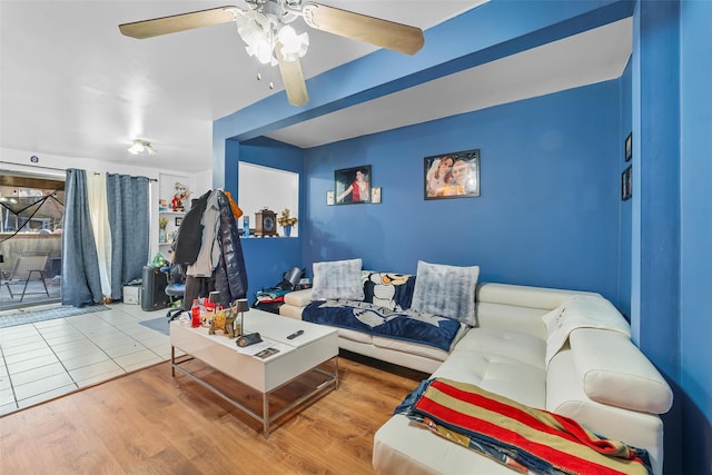 living room featuring a ceiling fan and wood finished floors