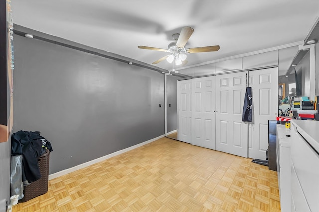 interior space featuring a ceiling fan, a closet, and baseboards