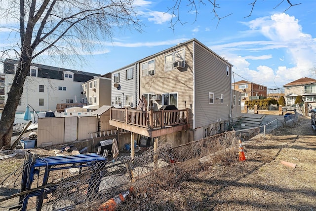 back of property featuring cooling unit, fence, a residential view, and a wooden deck