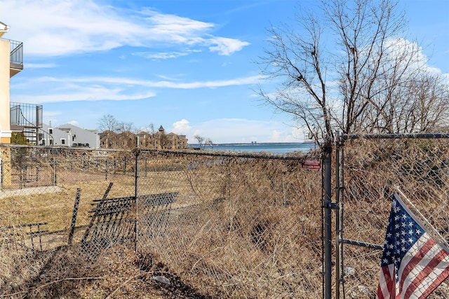 view of yard with a water view and fence