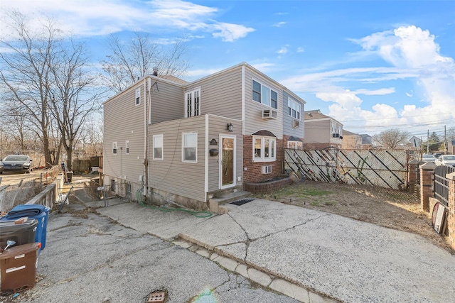 view of front of home featuring entry steps and fence