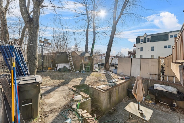 view of yard with an outbuilding, a fenced backyard, and a storage shed