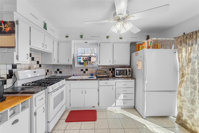 3296 Griswold Ave, Bronx, NY 10465 - kitchen featuring white appliances, a sink, tasteful backsplash, a ceiling fan, and white cabinetry