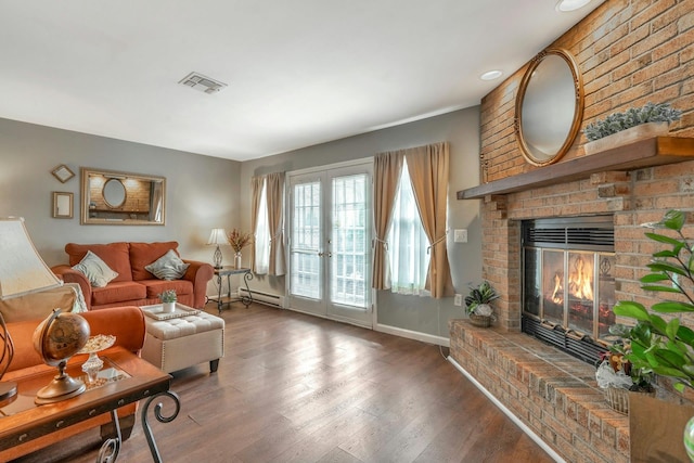 living area featuring visible vents, a baseboard radiator, wood finished floors, french doors, and a fireplace