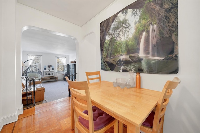 dining space featuring arched walkways