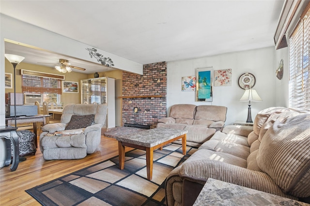 living room featuring wood finished floors and a ceiling fan