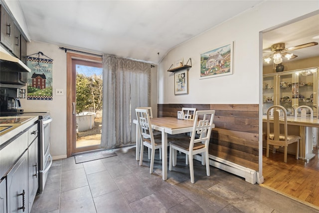 dining room featuring dark tile patterned flooring and ceiling fan