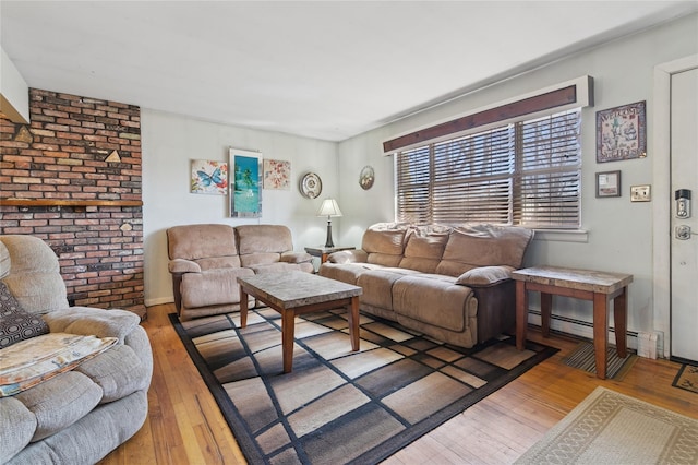 living area featuring a baseboard radiator and hardwood / wood-style floors