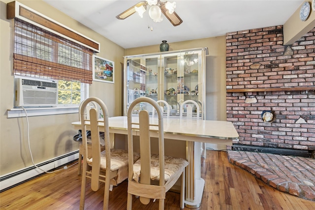 dining room featuring a baseboard radiator, wood-type flooring, ceiling fan, brick wall, and cooling unit