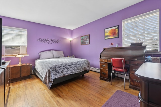 bedroom with light wood-style floors, a baseboard radiator, multiple windows, and cooling unit