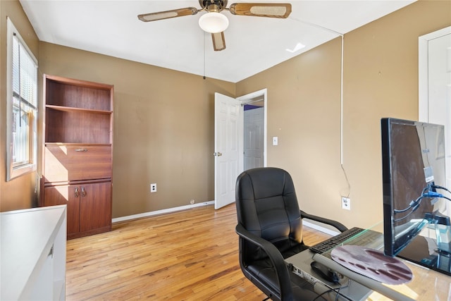 office space featuring light wood-type flooring, ceiling fan, and baseboards