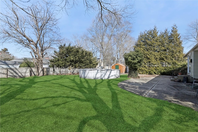 view of yard featuring fence, a fenced in pool, and a patio