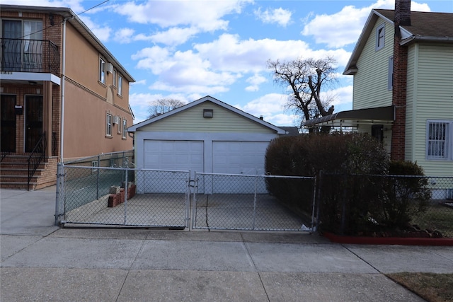 detached garage with fence and a gate