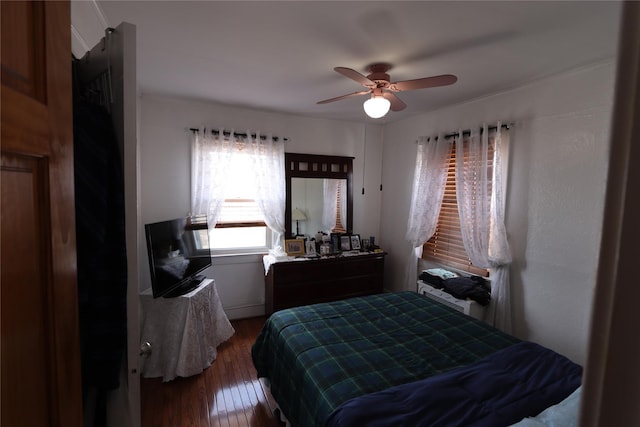 bedroom featuring hardwood / wood-style floors and a ceiling fan