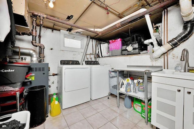 laundry area with light tile patterned floors and washer and dryer