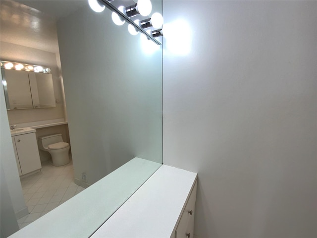 bathroom featuring toilet, tile patterned floors, and vanity