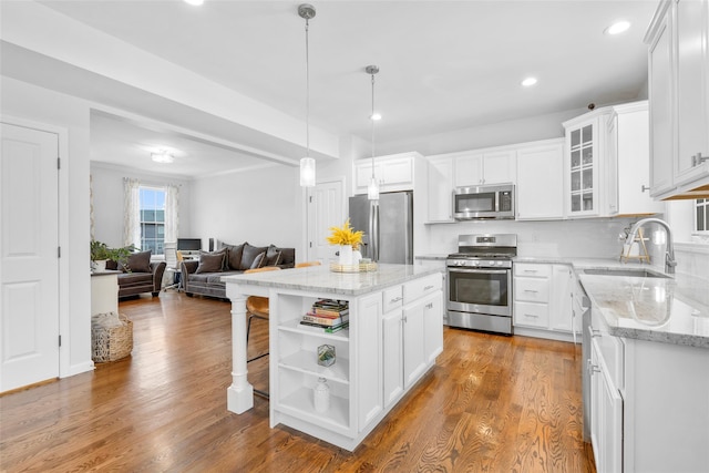 13 Hopkins Ct, Washingtonville, NY 10992 - kitchen with open floor plan, appliances with stainless steel finishes, wood finished floors, white cabinets, and open shelves