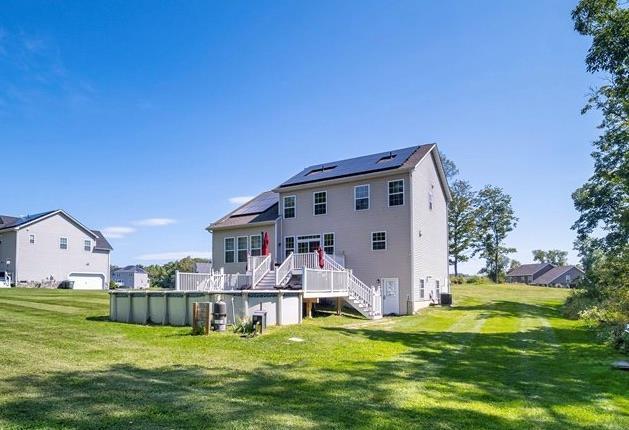 13 Hopkins Ct, Washingtonville, NY 10992 - rear view of property with solar panels, a yard, an outdoor pool, and stairs