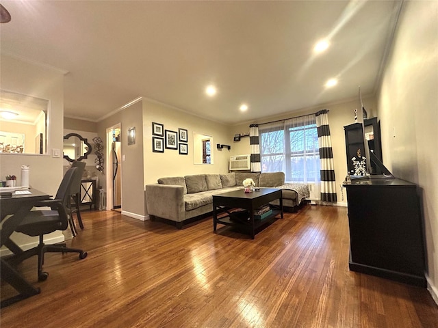 living room with dark wood-style floors, crown molding, and an AC wall unit