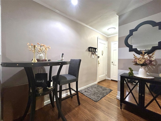 dining space with baseboards, wood finished floors, and crown molding