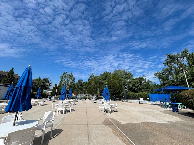 view of community with a patio area and fence