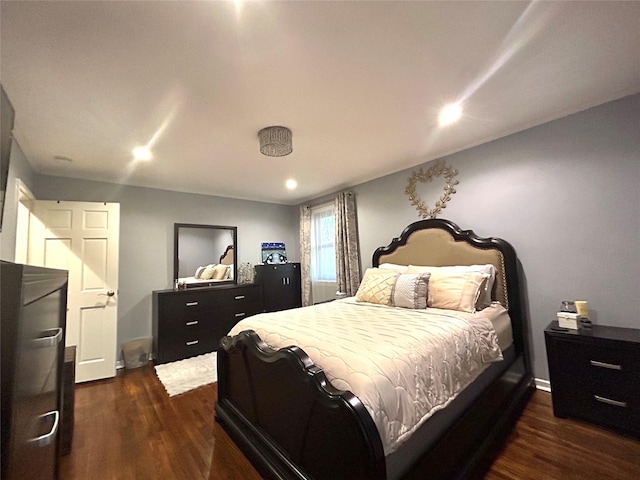 bedroom featuring baseboards and dark wood-type flooring