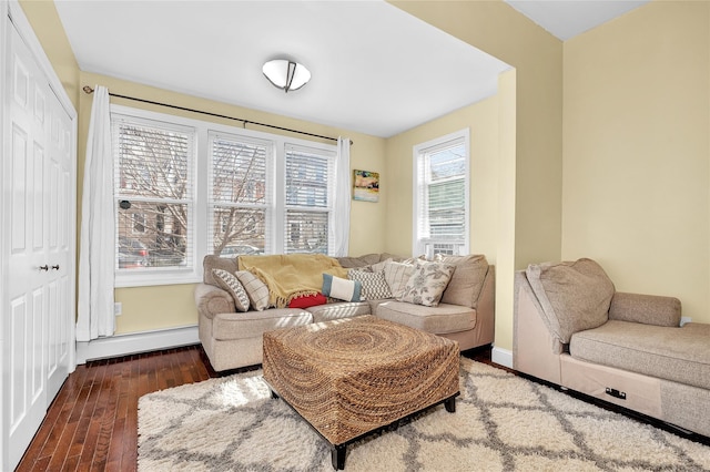 interior space featuring baseboards, a baseboard heating unit, and wood finished floors