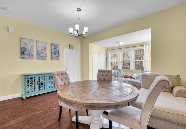 dining space with baseboards, dark wood-style flooring, and a notable chandelier