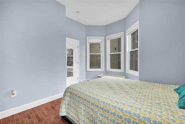 bedroom with dark wood-style floors and baseboards