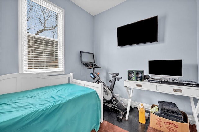 bedroom featuring baseboards and wood finished floors