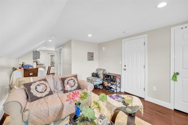 living room with recessed lighting, wood finished floors, baseboards, vaulted ceiling, and electric panel