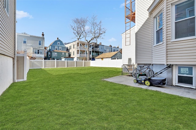 view of yard featuring a residential view and a fenced backyard