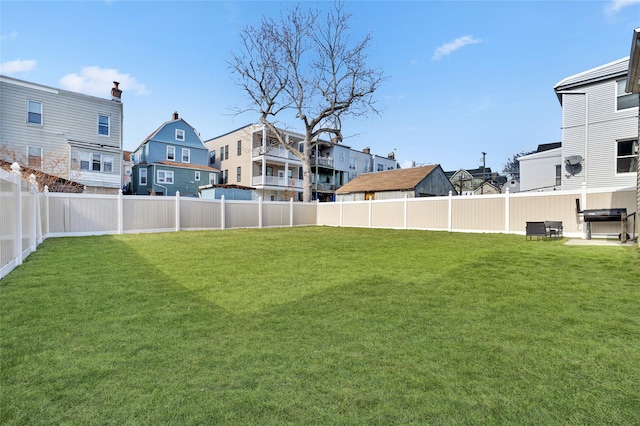 view of yard featuring a residential view and a fenced backyard