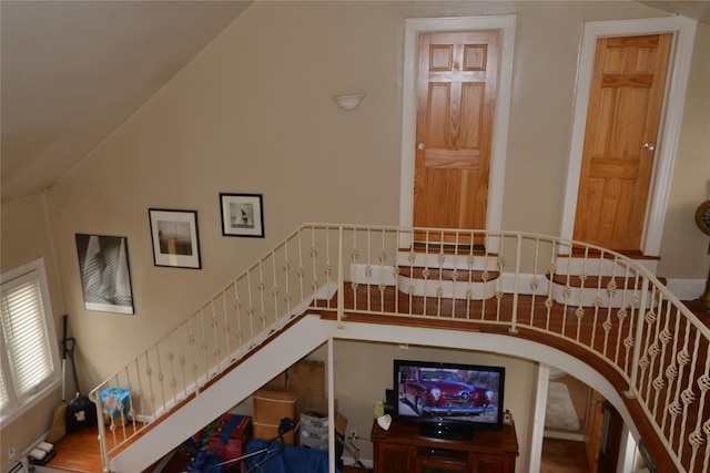 stairway featuring vaulted ceiling