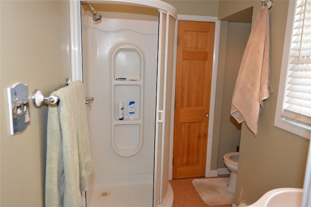 bathroom with toilet, a shower stall, and tile patterned floors