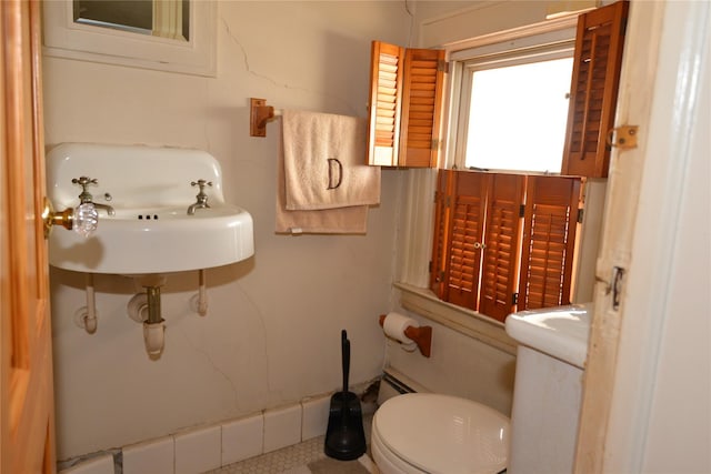 half bath featuring a sink and toilet