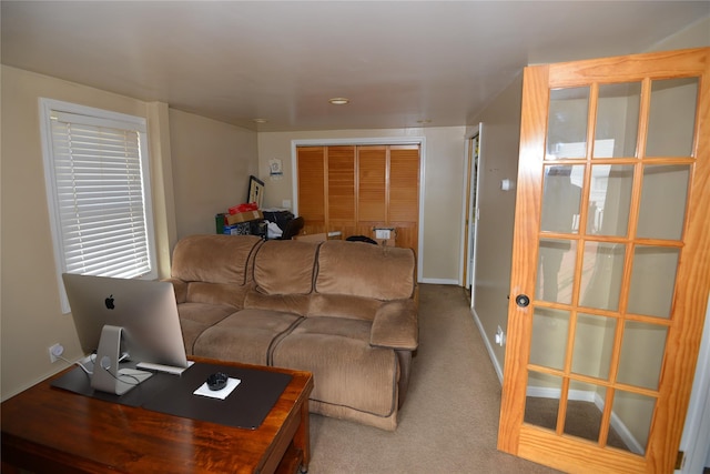 living room featuring carpet flooring and baseboards