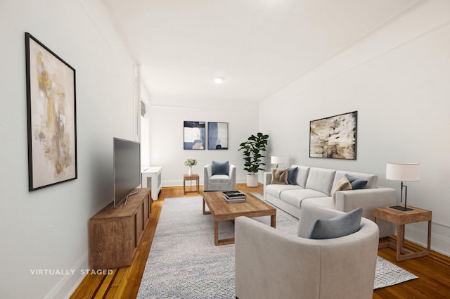 living room featuring baseboards and wood finished floors