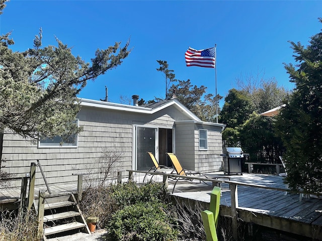 back of house with a deck