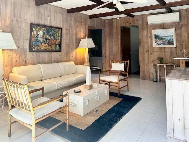 living area with wood walls, a ceiling fan, a wall mounted AC, beam ceiling, and tile patterned floors