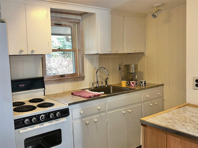 kitchen with tasteful backsplash, light countertops, white electric stove, and a sink