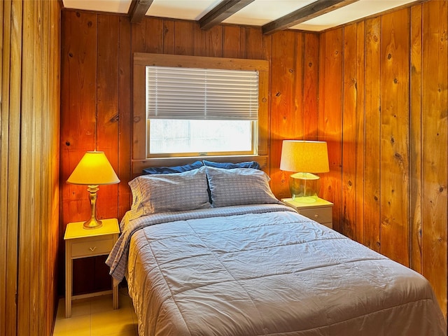 bedroom with wood walls and beam ceiling