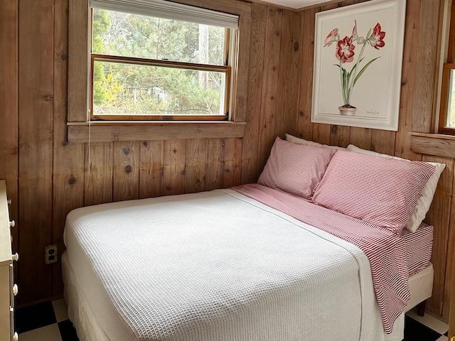 bedroom featuring wooden walls