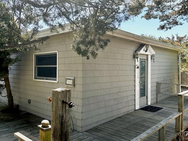 view of property exterior featuring a wooden deck