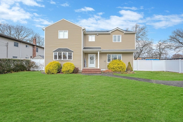 view of front of home featuring a front yard and fence