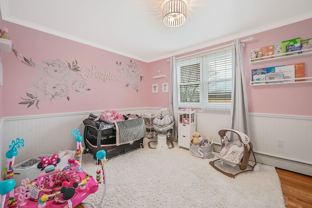 recreation room featuring a wainscoted wall and crown molding