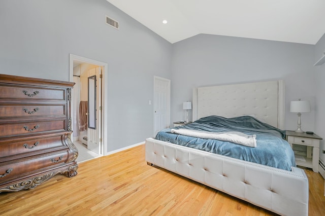 bedroom with a baseboard radiator, visible vents, vaulted ceiling, wood finished floors, and baseboards