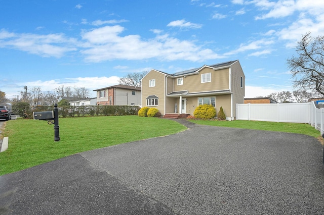 view of front of house with fence and a front yard